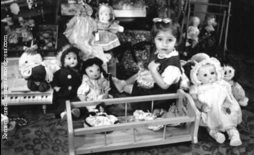 Little girl with Christmas toys, about 1948
