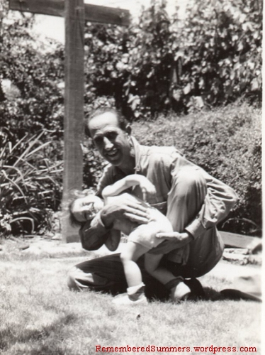 Giggling in my father's arms, late 1940s.